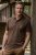 A hunter in a brown Ewident Deerhead hunting polo shirt in nature.