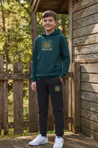 Chlapec oblečený v zelenej teplákovej súprave Ewident Tiger pre deti